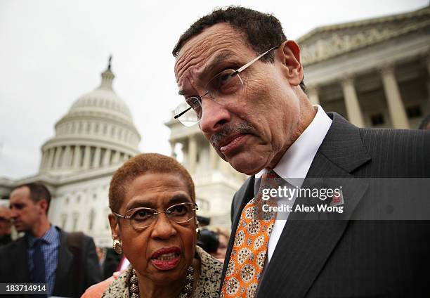 Washington, DC Mayor Vincent Gray listens to Delegate Eleanor Holmes Norton after a news conference with members of the D.C. Council "to call on the...