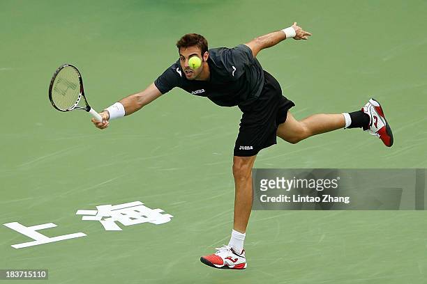 Marcel Granollers of Spain returns a shot to Novak Djokovic of Serbia during day three of the Shanghai Rolex Masters at the Qi Zhong Tennis Center on...
