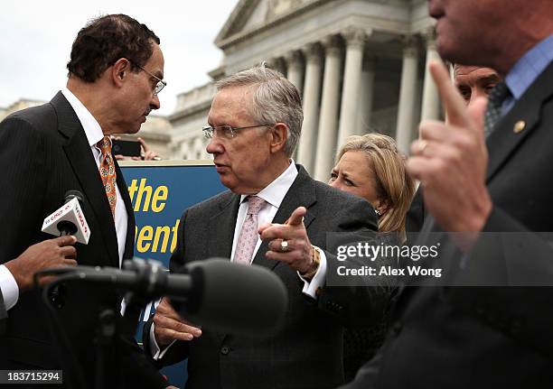 Senate Majority Leader Sen. Harry Reid gestures as Washington, DC Mayor Vincent Gray comes over from his news conference at the Senate Swamp and Sen....