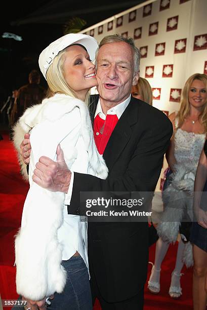 Socalite Paris Hilton greets playboy Hugh Hefner at the grand opening of the club/resturant White Lotus on March 7, 2003 in Hollywood, California.