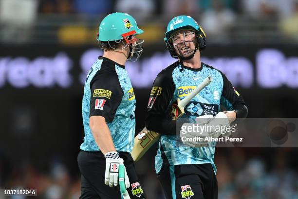Max Bryant and Colin Munro of the Heat leave the field at the conclusion of the first innings during the BBL match between Brisbane Heat and...