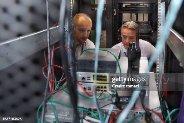 it professionals working in server room - old servers stock pictures, royalty-free photos & images