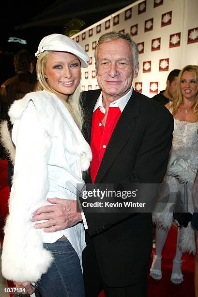 Socalite Paris Hilton greets playboy Hugh Hefner at the grand opening of the club/resturant White Lotus on March 7, 2003 in Hollywood, California.