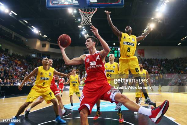 Nihad Djedovic of Muenchen is challenged by Keaton Grant of Ludwigsburg during the BBL match between MHP RIESEN Ludwigsburg and Bayern Muenchen at...