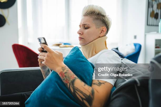 woman wearing a neck brace, cervical orthopaedic bandage having neck injury - bone fracture stock pictures, royalty-free photos & images