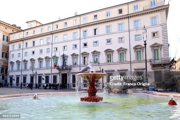 Gull stands on the fountain in front Palazzo Chigi after a press conference of the PDL Ministers on October 9, 2013 in Rome, Italy. After asking all...