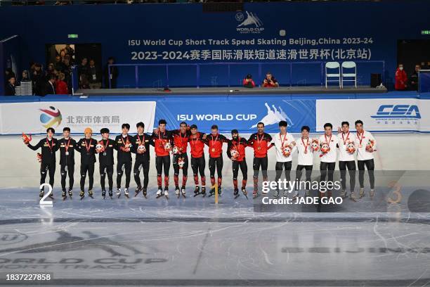 Canada's gold medallists , South Korea's silver medallists and China's bronze medallists attend the awards ceremony after the final A of the men's...