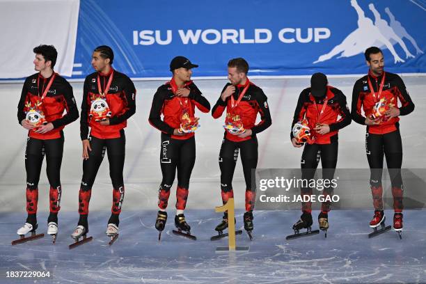 Canada's gold medallists attend the awards ceremony after the final A of the men's 5000m relay at the ISU World Cup Short Track Speed Skating event...