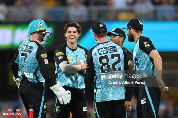 Mitch Swepson of the Heat celebrates with team mates after dismissing Joe Burns of the Stars during the BBL match between Brisbane Heat and Melbourne...