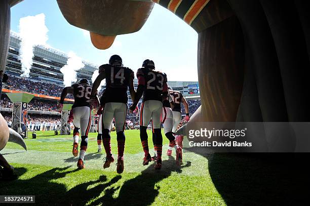 Zack Bowman of the Chicago Bears, Eric Weems and Devin Hester take the field against the New Orleans Saints on October 6, 2013 at Soldier Field in...