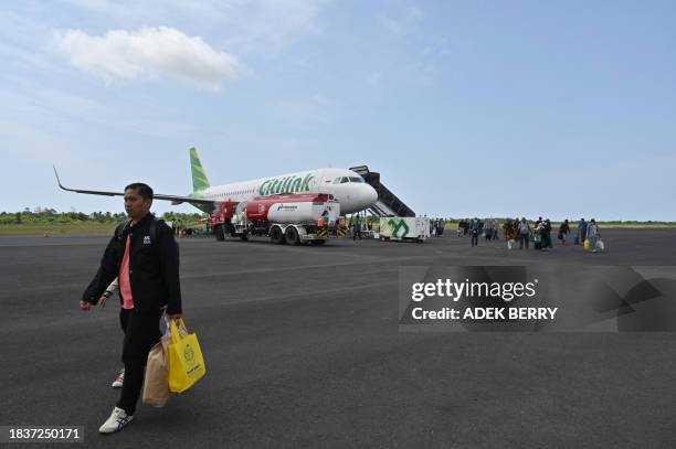 Passengers disembark from a Citilink Airbus A320 at Fatmawati Soekarno airport in Bengkulu, Sumatra on December 10, 2023.