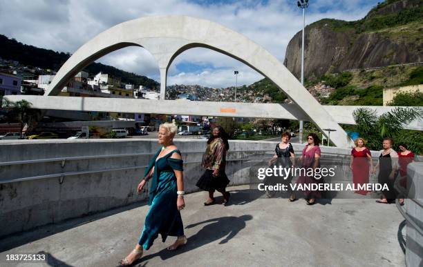 Senior women make a fashion show on a pedestrian bridge leading to the Rocinha shantytown in Rio de janeiro, Brazil, on October 9, 2013. The amateur...
