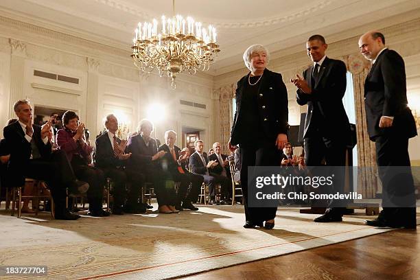 President Barack Obama applauds after a press conference to nominate Janet Yellen to head the Federal Reserve with current Fed Chair Ben Bernanke in...