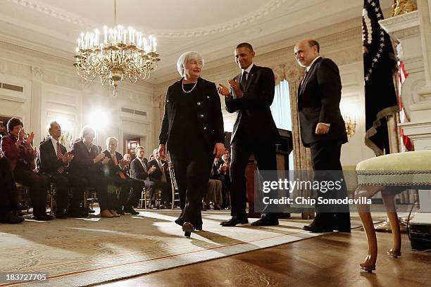 President Barack Obama applauds after a press conference to nominate Janet Yellen to head the Federal Reserve with current Fed Chair Ben Bernanke in...