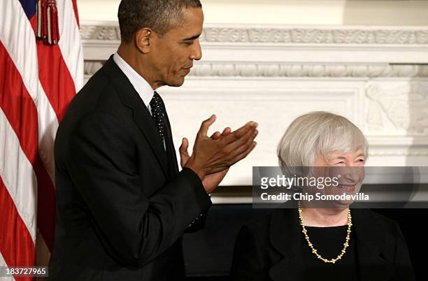 President Barack Obama claps as Janet Yellen smiles during a press conference to nominate her to head of the Federal Reserve in the State Dining Room...