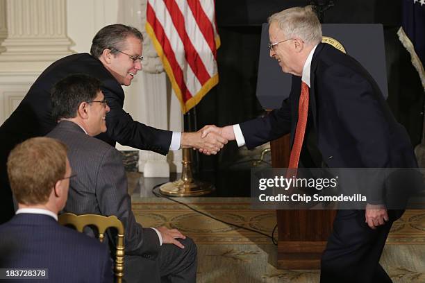 National Economic Council Director Gene Sperling and Treasury Secretary Jacob Lew greet George Akerlof, a Nobel prize-winning economist and professor...