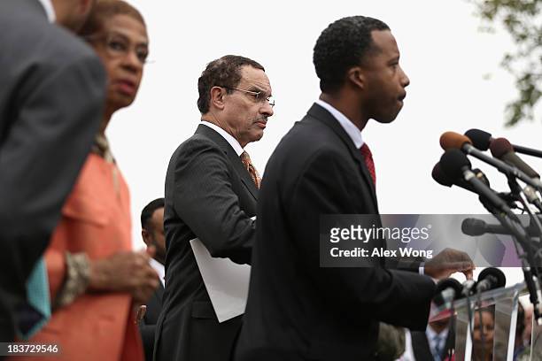 Washington, DC Councilmember Kenyan McDuffie speaks as Mayor Vincent Gray and Delegate Eleanor Holmes Norton listen during a news conference with...