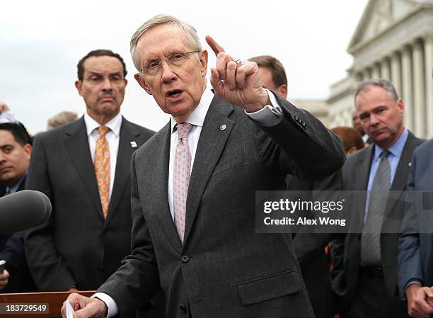 Senate Majority Leader Sen. Harry Reid speaks as Sen. Tim Kaine and Washington, DC Mayor Vincent Gray listen during a rally at the Senate steps...