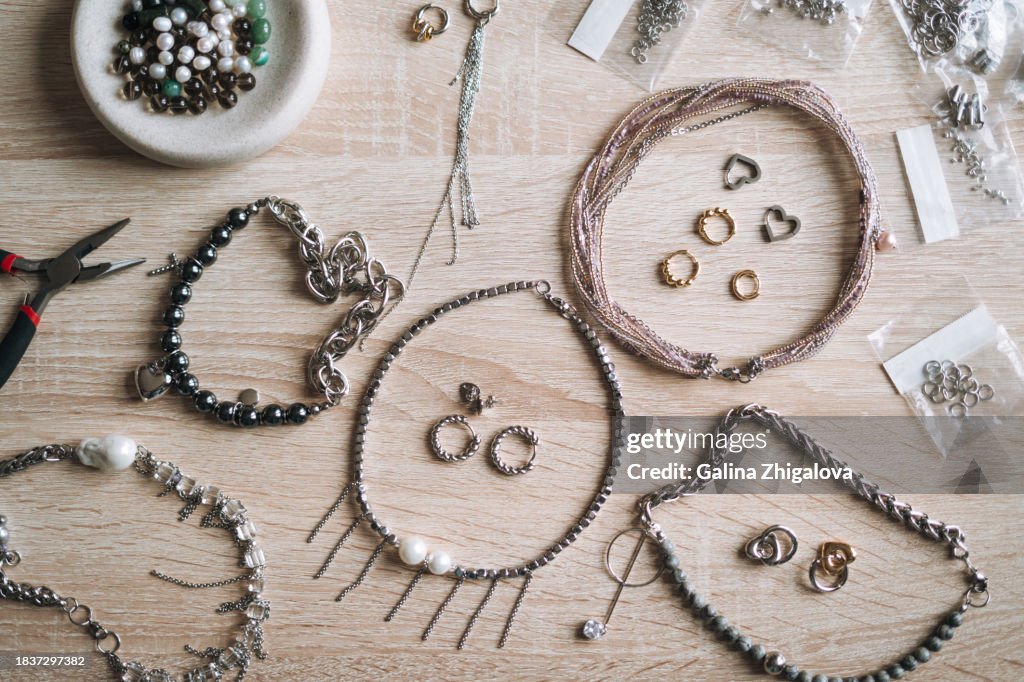 Top view of table with various tools for creating jewelry, the desktop of jewelry designer