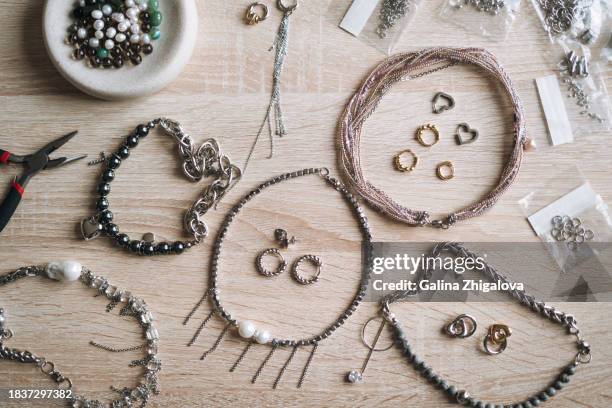 top view of table with various tools for creating jewelry, the desktop of jewelry designer - bead stock pictures, royalty-free photos & images