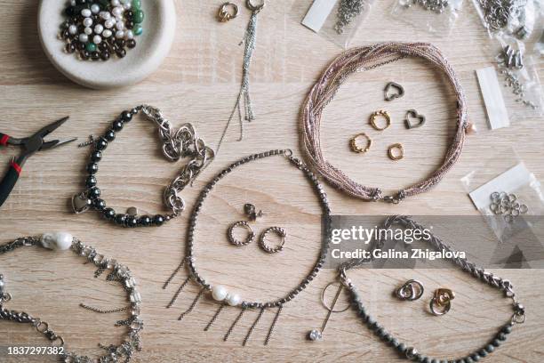 top view of table with various tools for creating jewelry, the desktop of jewelry designer - white bead stock pictures, royalty-free photos & images