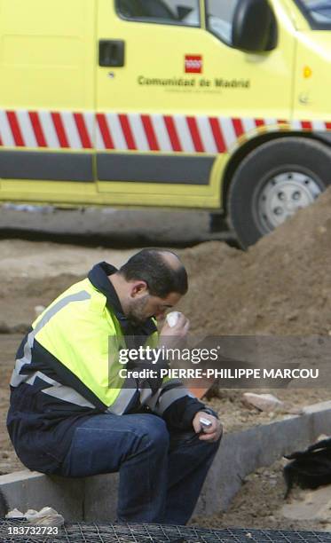 A rescue worker wipes his eyes after a train exploded at the Atocha train station in Madrid 11 March 2004. At least 173 people were killed and some...