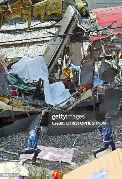 Policemen intervene after a train exploded at the Atocha train station in Madrid 11 March 2004. At least 173 people were killed and some 600 injured...