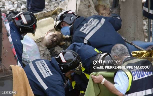 Rescue workers free bodies from the train after it exploded at the Atocha train station in Madrid 11 March 2004. At least 173 people were killed and...