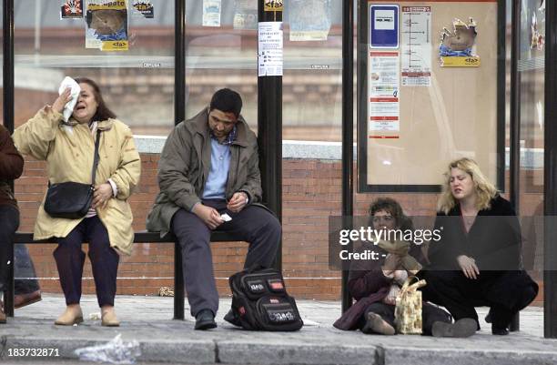 Victims sit down after a train exploded at the Atocha train station in Madrid 11 March 2004. At least 198 people were killed and more than 1400...