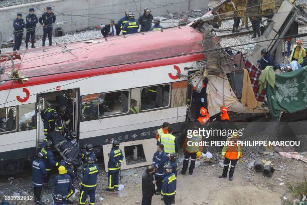 Rescue workers evacuate the body of a victim after a train exploded at the Atocha train station in Madrid 11 March 2004. At least 173 people were...
