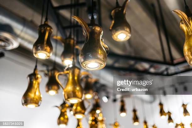 cezve lamps hanging from the ceiling in a coffee shop in kuwait - old kuwait stock pictures, royalty-free photos & images