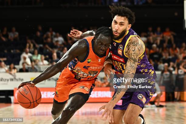 Bul Kuol of the Taipans drives up court under pressure from Denzel Valentine of the Kings during the round 10 NBL match between Cairns Taipans and...
