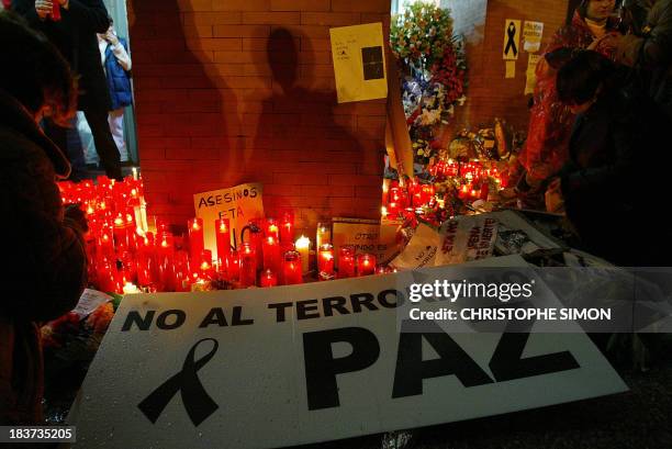 People light candles at Atocha train station against rail bombings which left 198 dead and over 1400 injured the day before, 12 March 2004 in Madrid,...