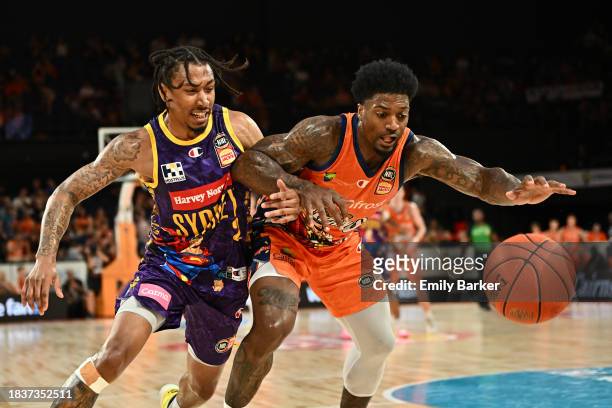 Patrick Miller of the Taipans and Jaylen Adams of the Kings complete for the ball during the round 10 NBL match between Cairns Taipans and Sydney...