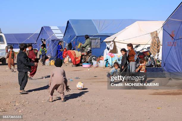 Afghan children play near their makeshift tents at Nayeb Rafi village in Zendeh Jan district of Herat province on December 10 since houses were...