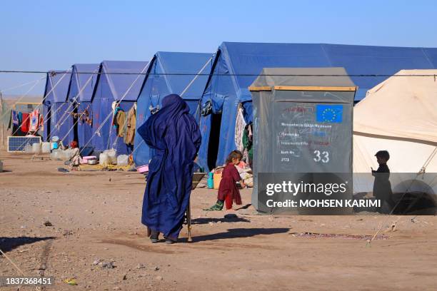 Afghan children play near their makeshift tents at Nayeb Rafi village in Zendeh Jan district of Herat province on December 10 since houses were...