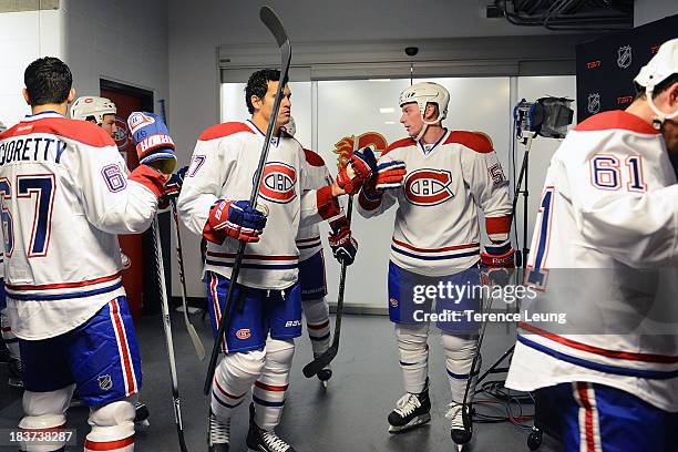 Rene Bourque and teammates of the Montreal Canadiens prepare to go on the ice for warmups before the game against the Calgary Flames at Scotiabank...