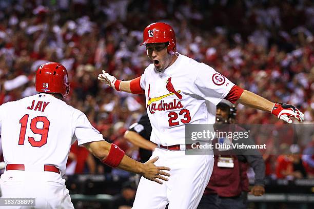 David Freese of the St. Louis Cardinals celebrates his two-run home run scoring Jon Jay of the St. Louis Cardinals in the second inning against the...