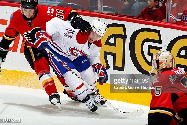 Mikael Backlund of the Calgary Flames skates against David Desharnais of the Montreal Canadiens at Scotiabank Saddledome on October 9, 2013 in...