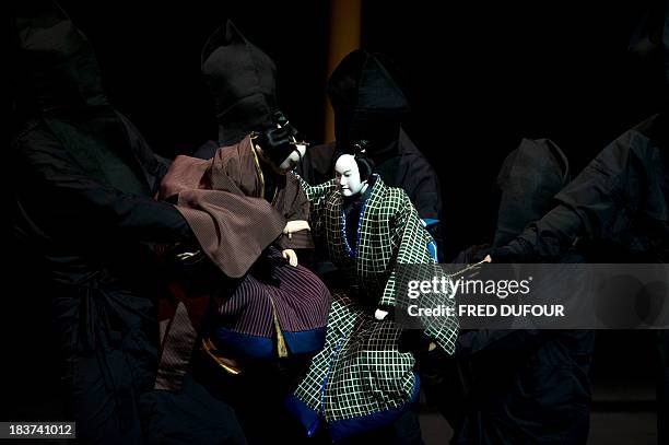 Actors play Japan's traditional puppet theatre "Bunraku" during a rehearsal of the play "Sonezaki Shinju" by Japanese photographer Hiroshi Sugimoto...