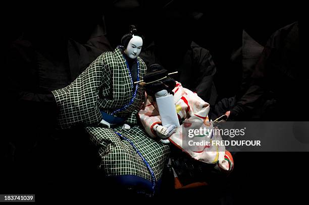 Actors play Japan's traditional puppet theatre "Bunraku" during a rehearsal of the play "Sonezaki Shinju" by Japanese photographer Hiroshi Sugimoto...