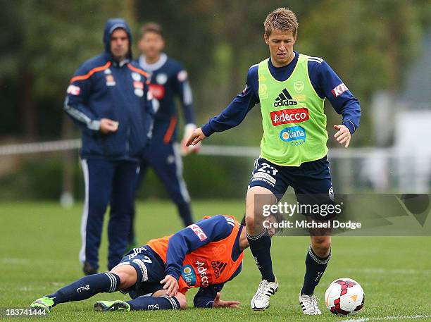 Guilherme Finkler reacts after a contest with Adrian Leijer during a Melbourne Victory A-League training session at Gosch's Paddock on October 10,...