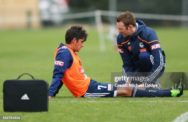 Guilherme Finkler gets his knee checked after a contest with Adrian Leijer during a Melbourne Victory A-League training session at Gosch's Paddock on...