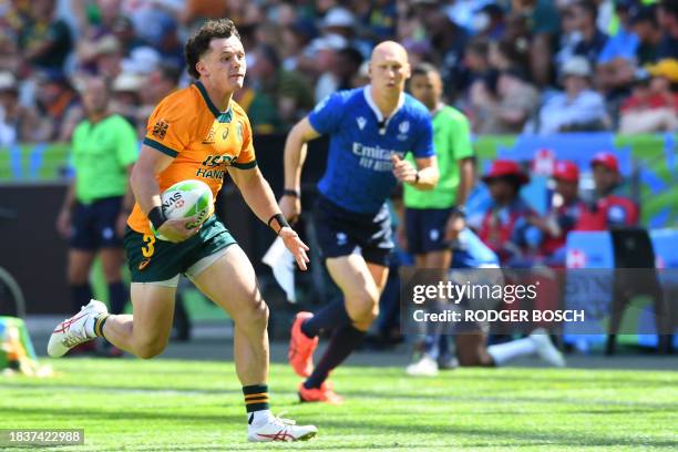 Australia's Henry Palmer runs with the ball during the men's HSBC World Rugby Sevens Series 2023 semi-final match between Argentina and Ireland at...