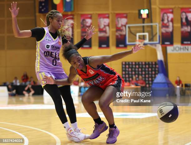 Aari McDonald of the Lynx looses control of the ball against Jordin Canada of the Boomers during the WNBL match between Perth Lynx and Melbourne...