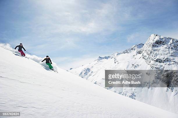 two women skiing - skipiste stockfoto's en -beelden