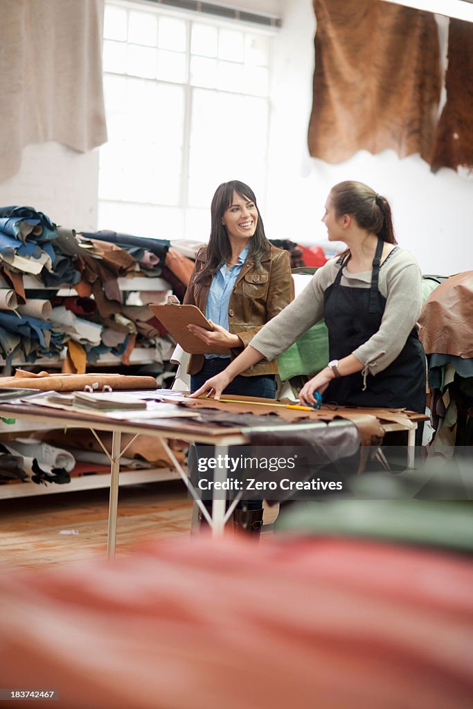 Worker and manager in leather workshop