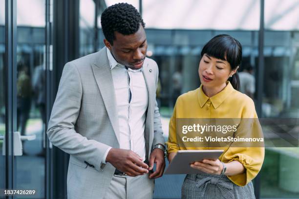 business people using digital tablet outdoors. - executive board meetings stock pictures, royalty-free photos & images