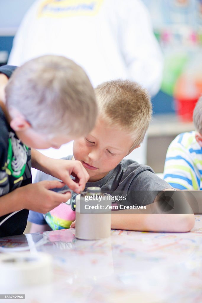 Boys making craft object