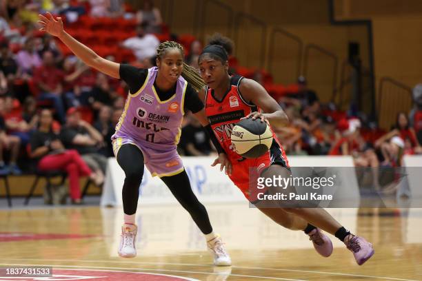 Aari McDonald of the Lynx drives to the key against Jordin Canada of the Boomers during the WNBL match between Perth Lynx and Melbourne Boomers at...